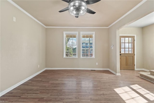 interior space featuring wood-type flooring, ceiling fan, and crown molding