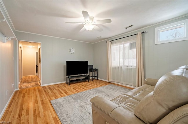 living room with ceiling fan, ornamental molding, and wood-type flooring