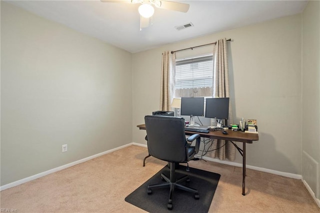 home office featuring light carpet and ceiling fan