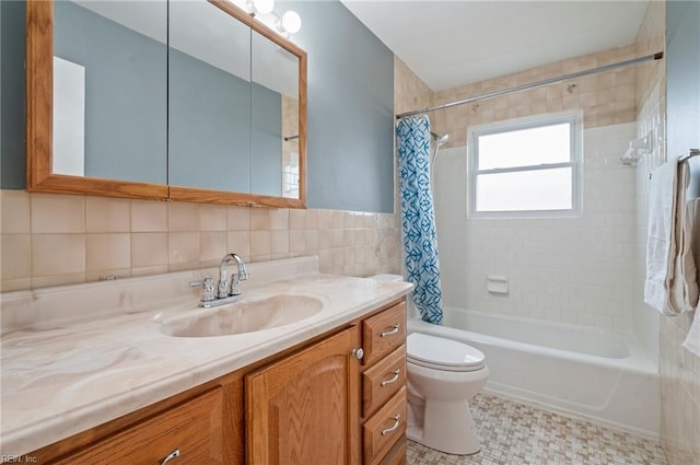 full bathroom with tile walls, vanity, shower / bath combination with curtain, and toilet