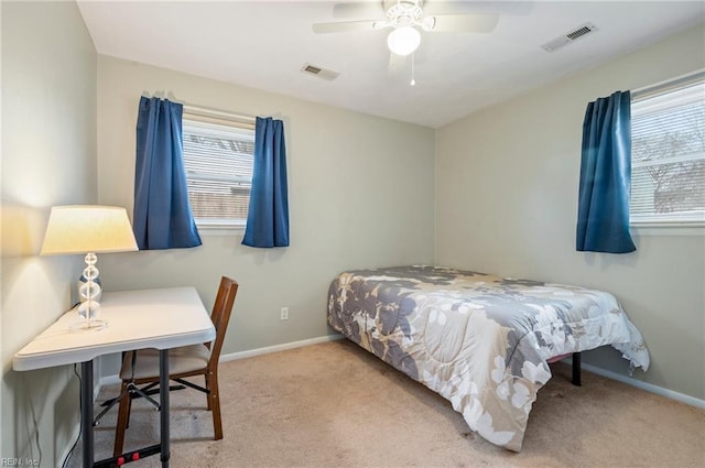 bedroom with ceiling fan and light carpet