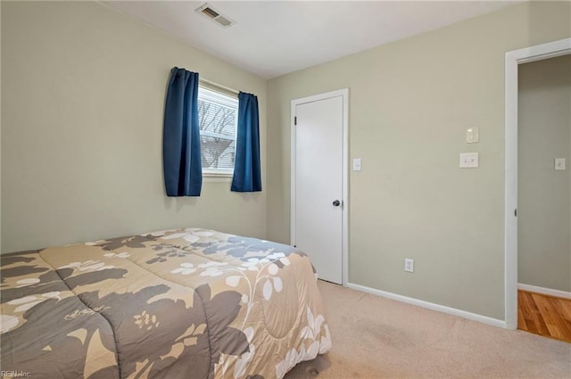 bedroom featuring light colored carpet