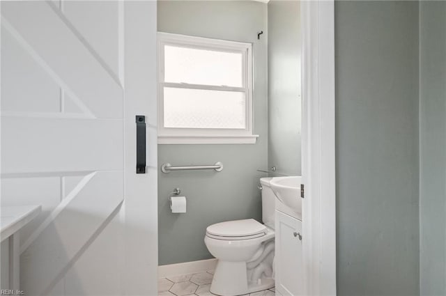 bathroom featuring vanity, tile patterned floors, and toilet