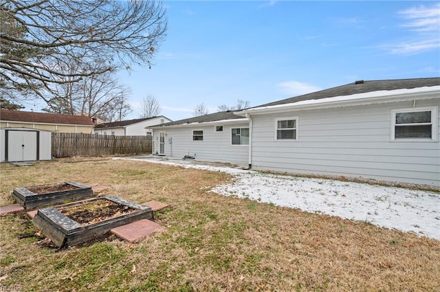 rear view of house with a shed and a lawn