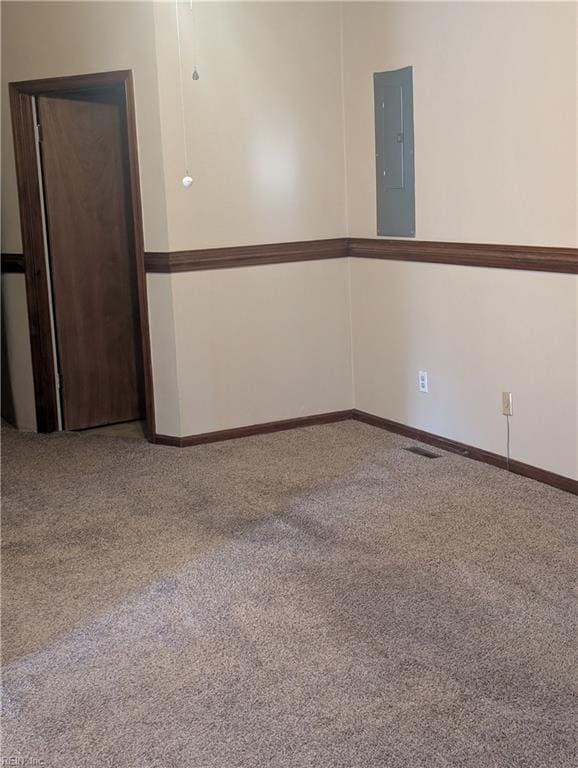 carpeted empty room with electric panel