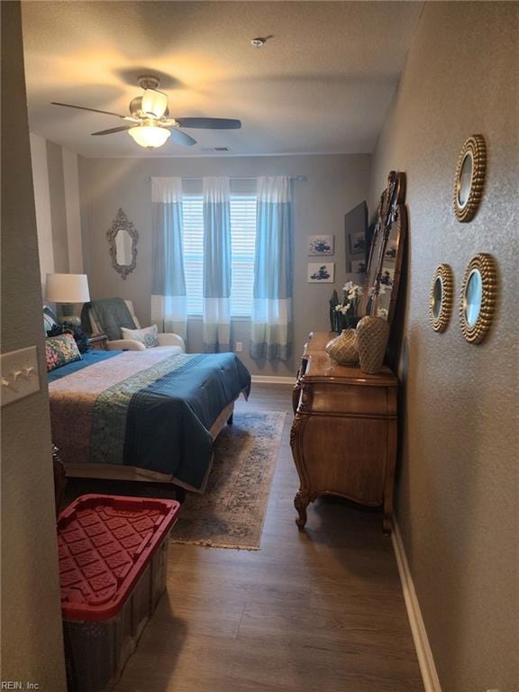 bedroom featuring dark wood-type flooring and ceiling fan