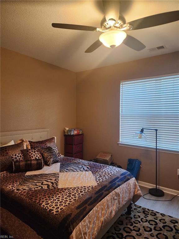 bedroom featuring hardwood / wood-style flooring and ceiling fan