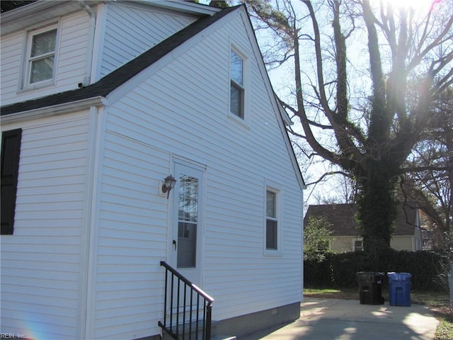 view of property exterior with a patio area