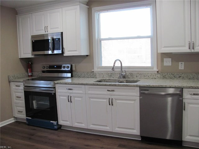 kitchen with white cabinetry, stainless steel appliances, sink, and a wealth of natural light