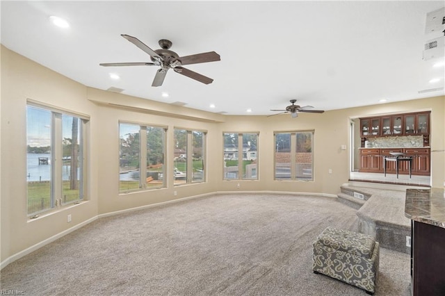 unfurnished living room featuring carpet floors, recessed lighting, ceiling fan, and baseboards