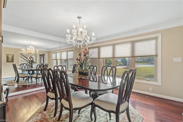 dining area featuring a chandelier, visible vents, crown molding, and hardwood / wood-style flooring