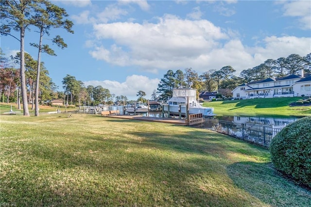 view of property's community with a yard and a water view