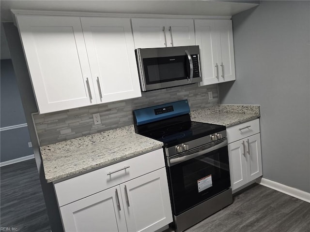 kitchen with white cabinetry, stainless steel appliances, and decorative backsplash