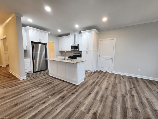 kitchen with stainless steel appliances, white cabinetry, hardwood / wood-style flooring, and light stone counters