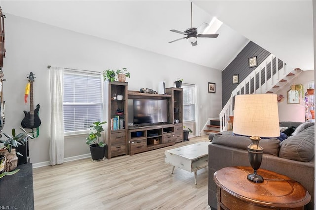 living room with vaulted ceiling, ceiling fan, and light hardwood / wood-style flooring