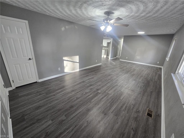 spare room featuring dark wood-type flooring and ceiling fan