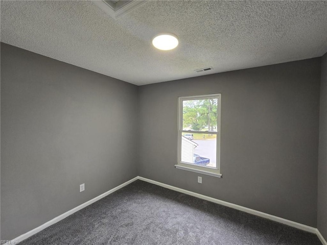 spare room with carpet floors and a textured ceiling