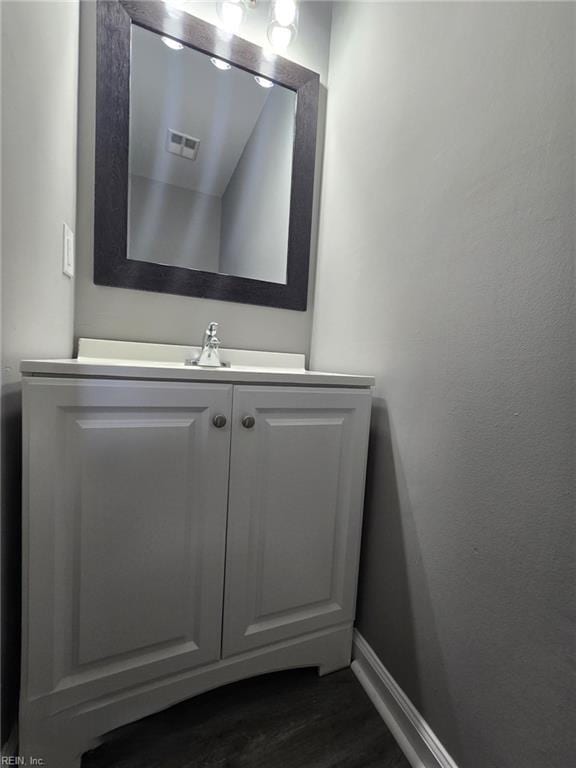 bathroom with vanity and hardwood / wood-style flooring