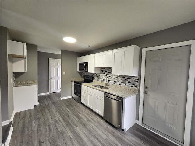 kitchen with white cabinetry, sink, hardwood / wood-style flooring, and appliances with stainless steel finishes