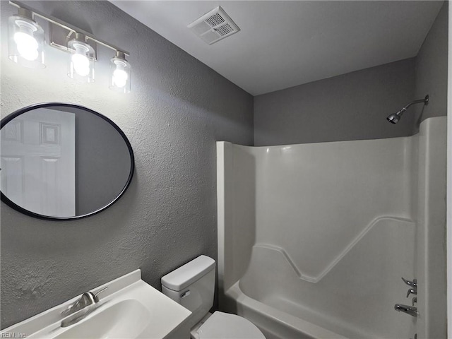 full bathroom featuring toilet, vanity, and bathtub / shower combination