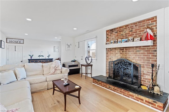 living room with a fireplace and wood-type flooring