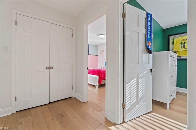 hallway with light hardwood / wood-style floors