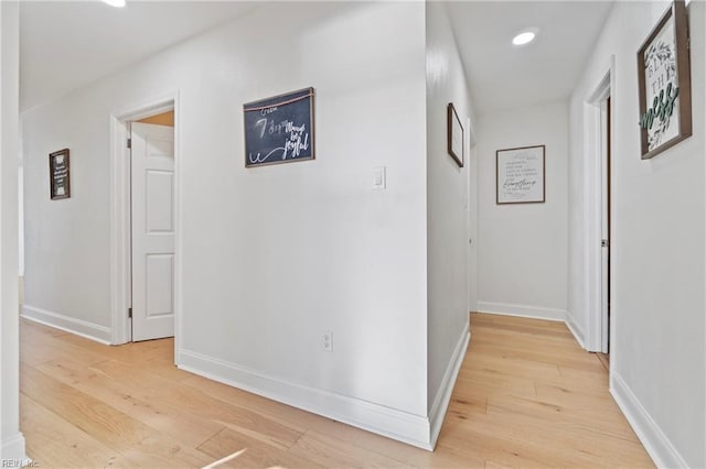 corridor with light hardwood / wood-style floors