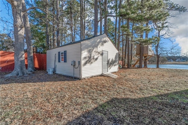 view of outbuilding featuring a water view and central air condition unit