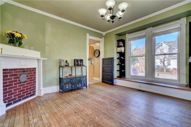 unfurnished living room featuring ornamental molding, a chandelier, and light hardwood / wood-style floors