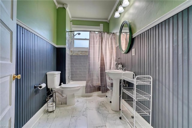 bathroom with crown molding, shower / bath combination with curtain, and toilet