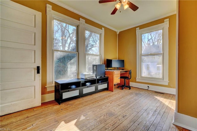 office area featuring crown molding, a healthy amount of sunlight, ceiling fan, and light wood-type flooring