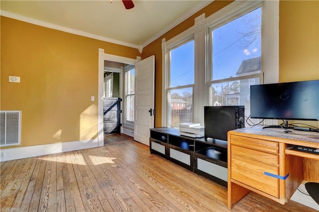 office space with ornamental molding, ceiling fan, and light wood-type flooring