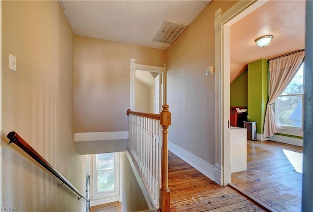 stairs featuring hardwood / wood-style flooring