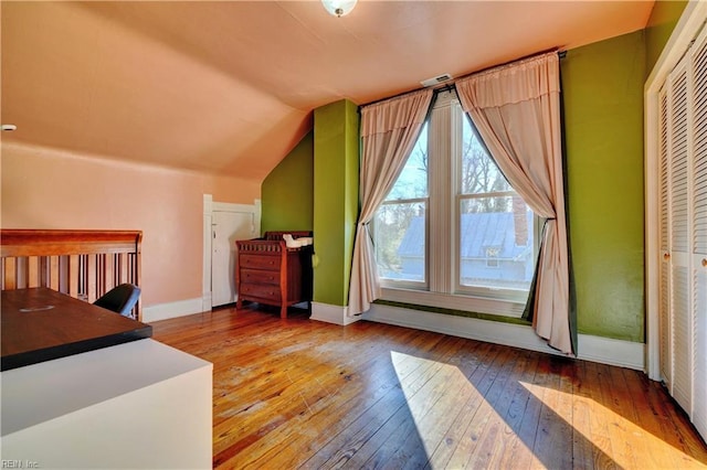 additional living space featuring light hardwood / wood-style floors and vaulted ceiling