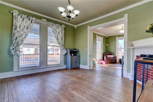 dining space featuring a notable chandelier, crown molding, and wood-type flooring