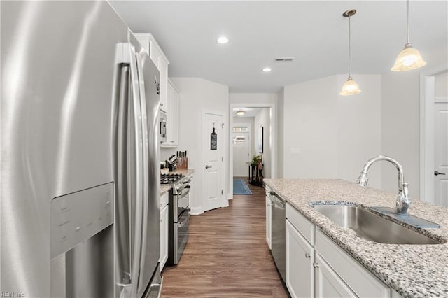 kitchen with white cabinetry, stainless steel appliances, and sink