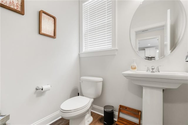 bathroom featuring sink, hardwood / wood-style floors, and toilet