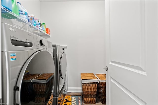 clothes washing area with washer and dryer