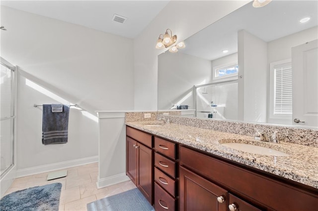 bathroom featuring vanity, tile patterned floors, and a shower with shower door