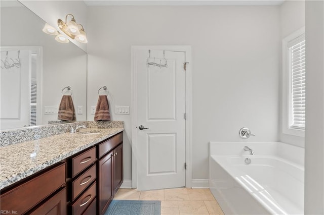 bathroom with vanity, tile patterned flooring, and a washtub