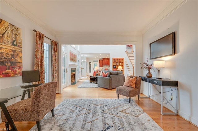 sitting room featuring light hardwood / wood-style flooring and ornamental molding