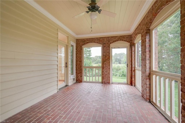 unfurnished sunroom with ceiling fan