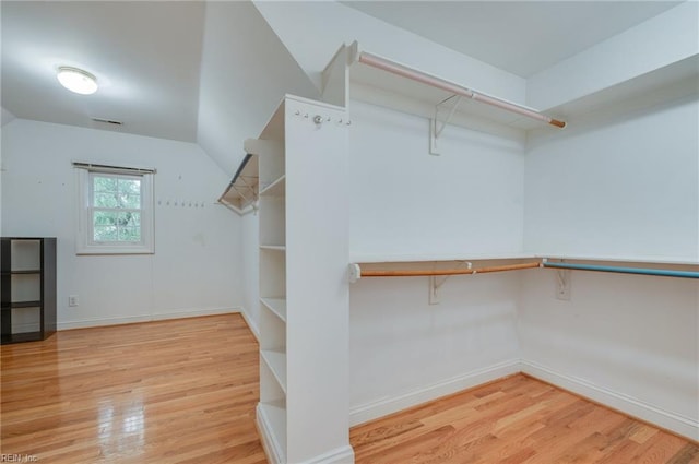 spacious closet featuring hardwood / wood-style flooring and lofted ceiling