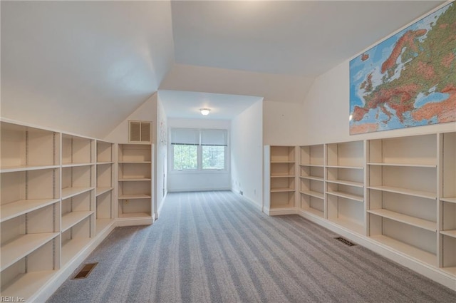 bonus room featuring carpet floors, built in features, and vaulted ceiling