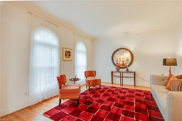 sitting room with crown molding and wood-type flooring