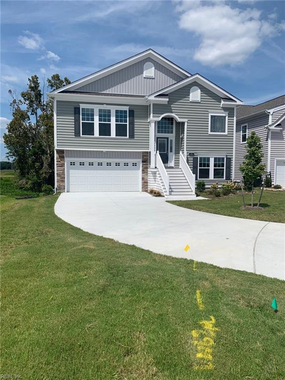 split foyer home with a garage and a front yard