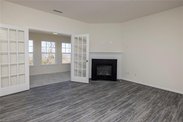 unfurnished living room featuring french doors