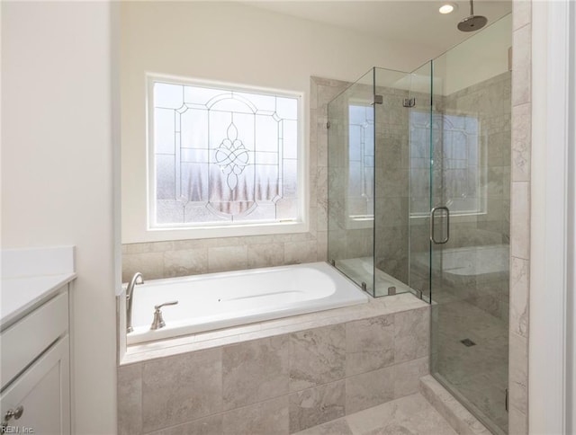 bathroom with vanity and separate shower and tub