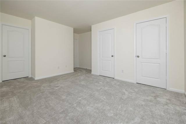 unfurnished bedroom with light colored carpet