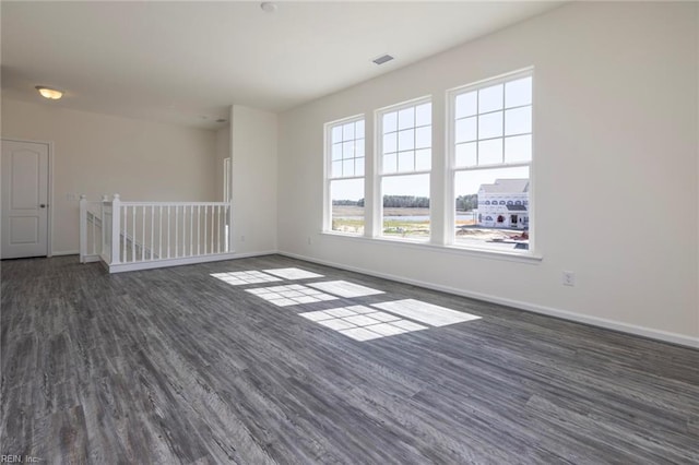 spare room featuring dark hardwood / wood-style flooring